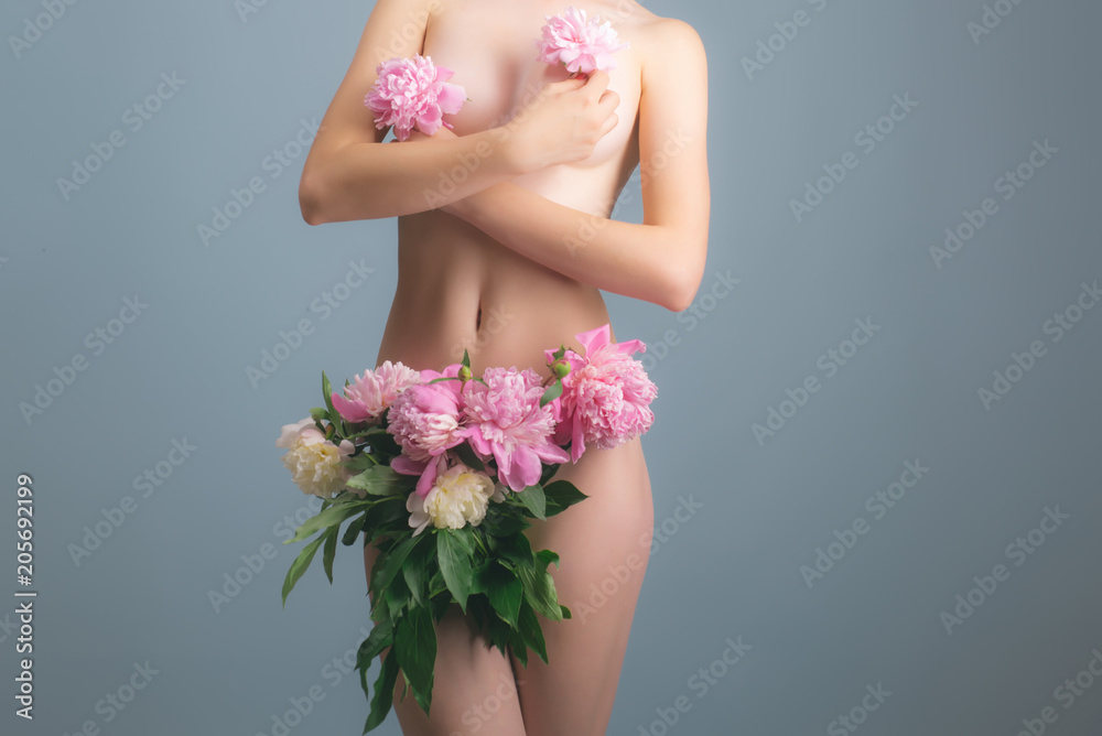 Vagina and female breast under flowers. Naked body and sexy woman. Bra and  panties concept. Flowers