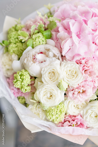 Floristry concept. Bouquet of beautiful flowers on gray table. Spring colors. the work of the florist at a flower shop.