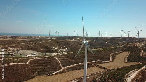 Aerial view of windmills in the mountains, wind power turbines. Wind turbine close-up against a background of mountains.