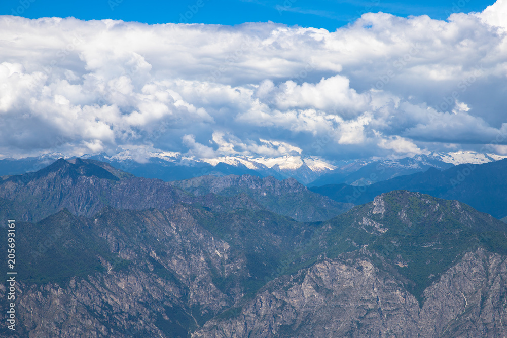 Panorama of the gorgeous  alps mountains Monte Baldo mountain and white clouds Macesine, Provincia di Verona, Veneto, Italy