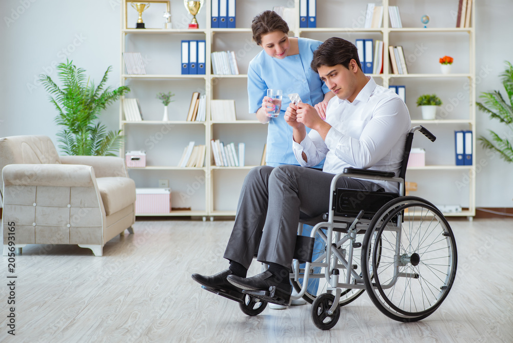 Disabled patient on wheelchair visiting doctor for regular check Disabled patient on wheelchair visiting doctor for regular check