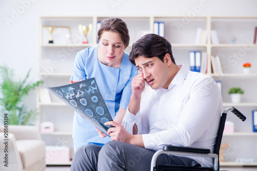 Doctor discussing x-ray image with patient © Elnur