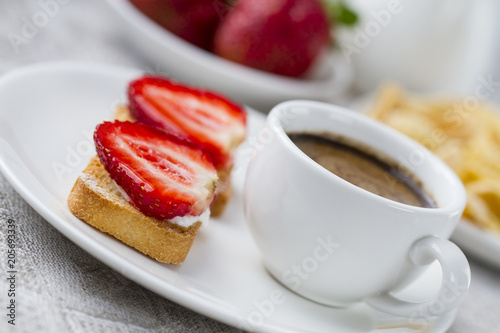 Toast with fresh strawberry and coffee