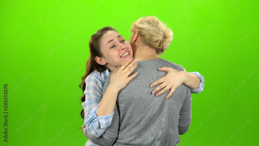 Native hugs, they are stand and talking. The daughter hugs her mother. Green screen Native hugs, they are stand and talking. The daughter hugs her mother. Green screen