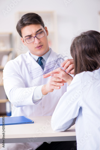 Doctor checking patients joint flexibility with gonimeter