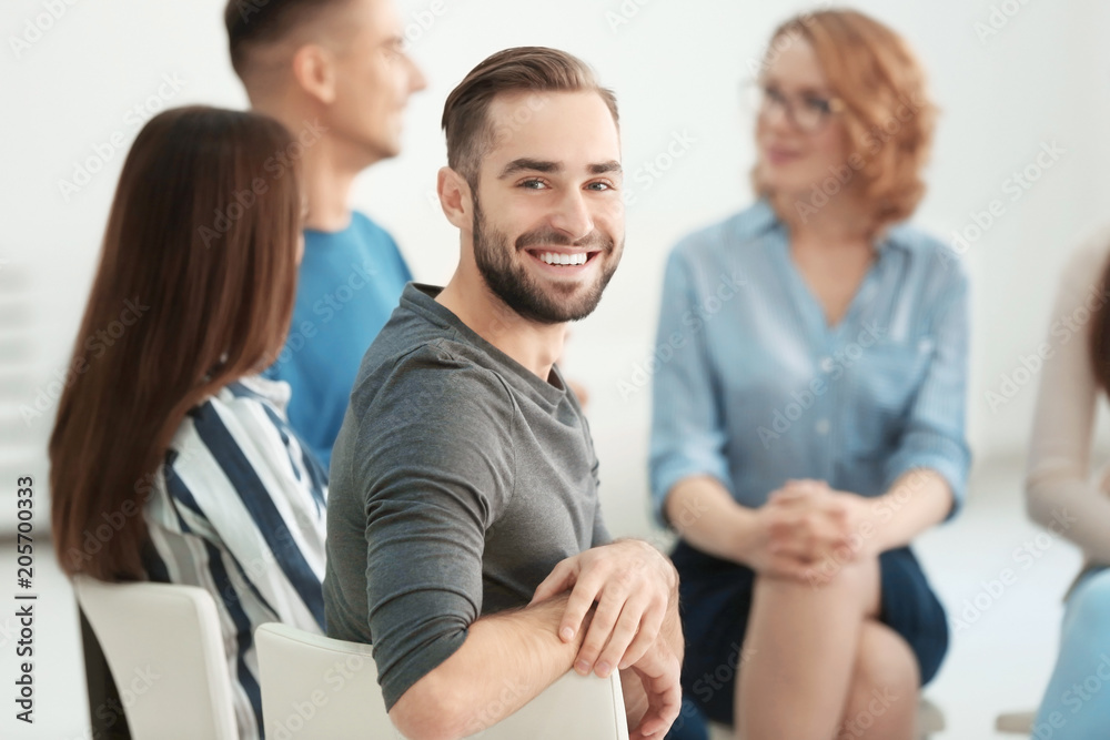 Handsome man at group psychotherapy session indoors Handsome man at group psychotherapy session indoors