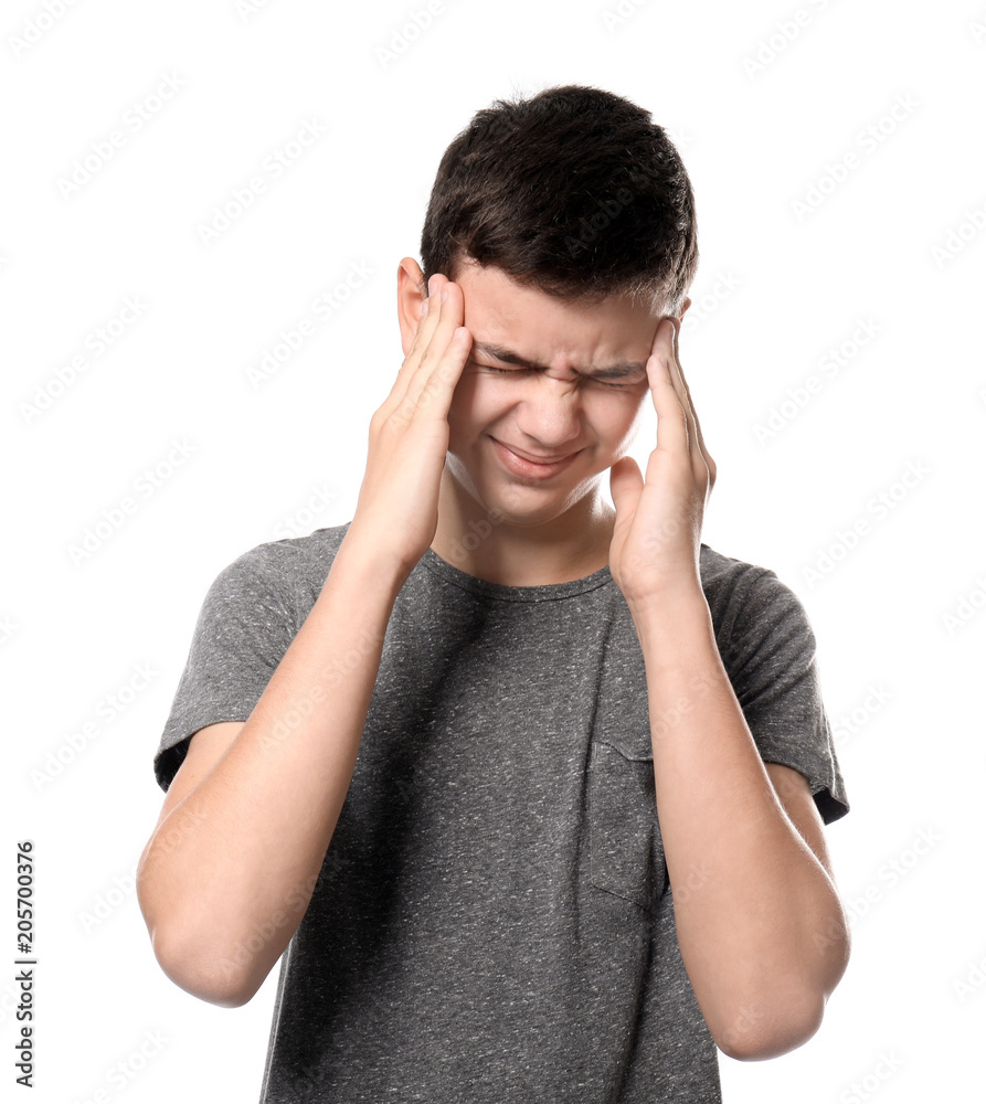 Teenage boy suffering from headache on white background
