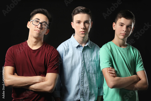 Cool teenage boys on dark background