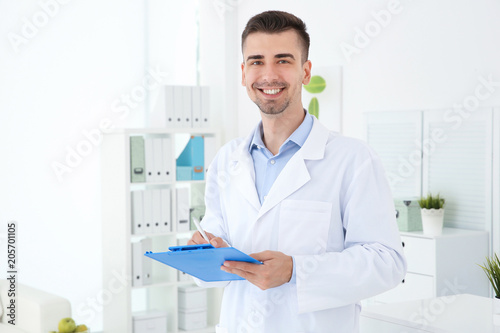 Young male receptionist working in hospital