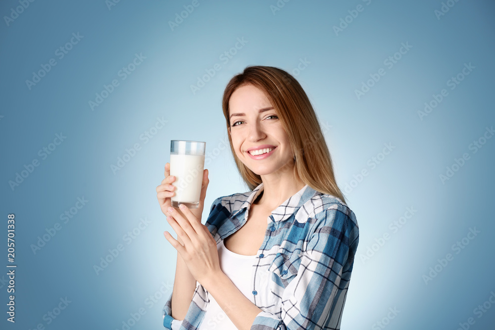 Beautiful young woman drinking milk on color background Beautiful young woman drinking milk on color background