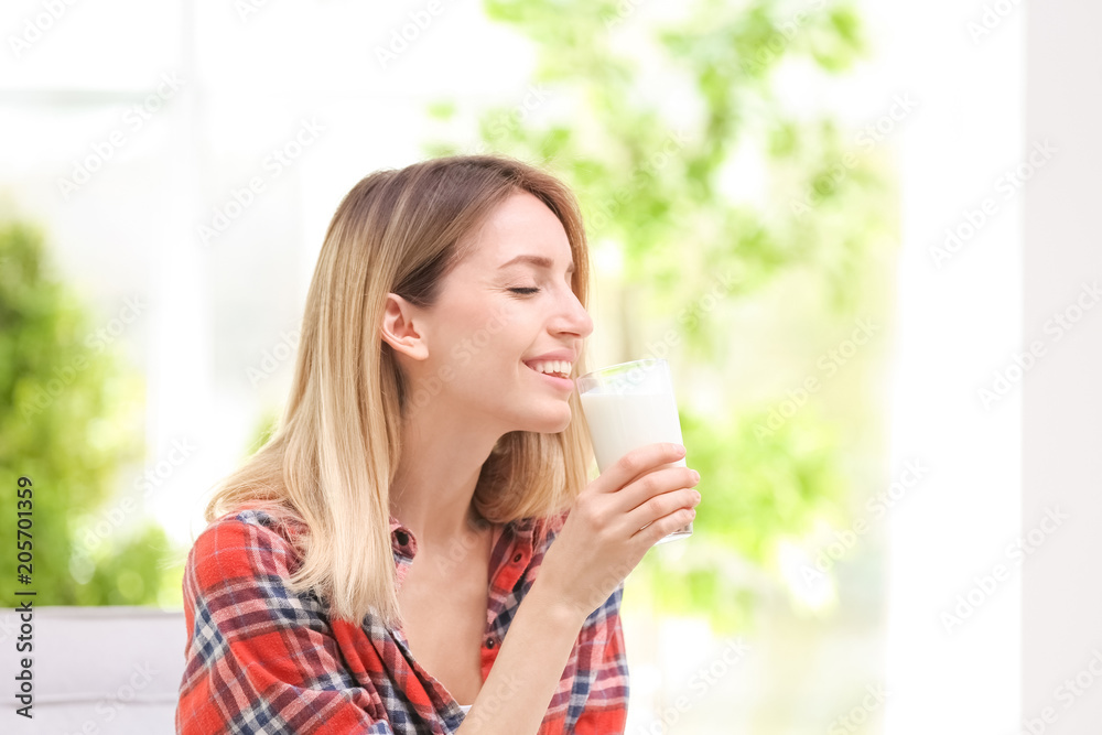 Beautiful young woman drinking milk at home Beautiful young woman drinking milk at home