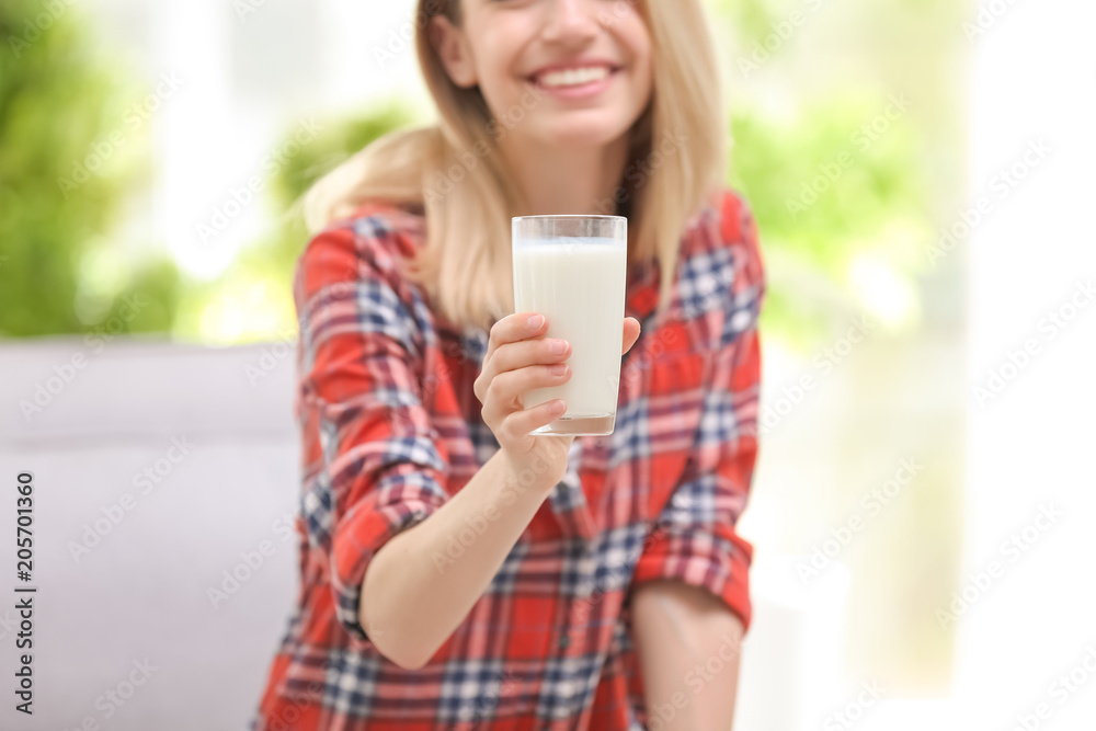 Beautiful young woman drinking milk at home Beautiful young woman drinking milk at home