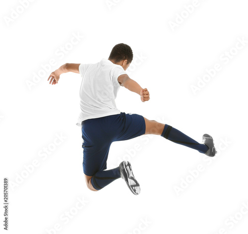 Teenage African-American boy playing football on white background