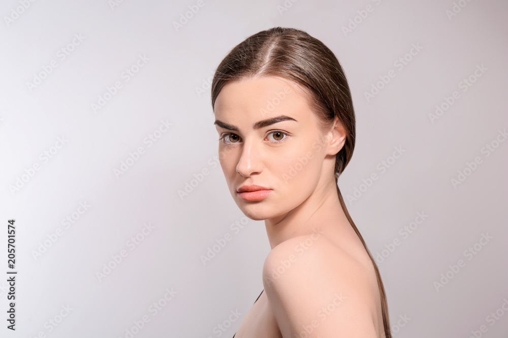 Beautiful woman with perfect eyebrows on light background Beautiful woman with perfect eyebrows on light background