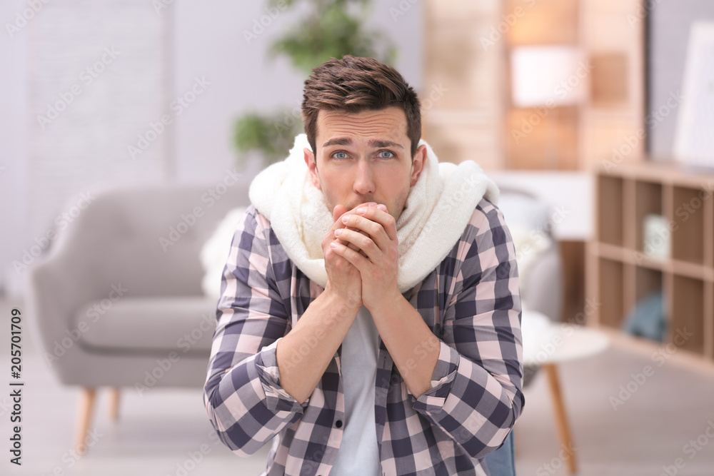 Sad young man suffering from cold on blurred background Sad young man suffering from cold on blurred background
