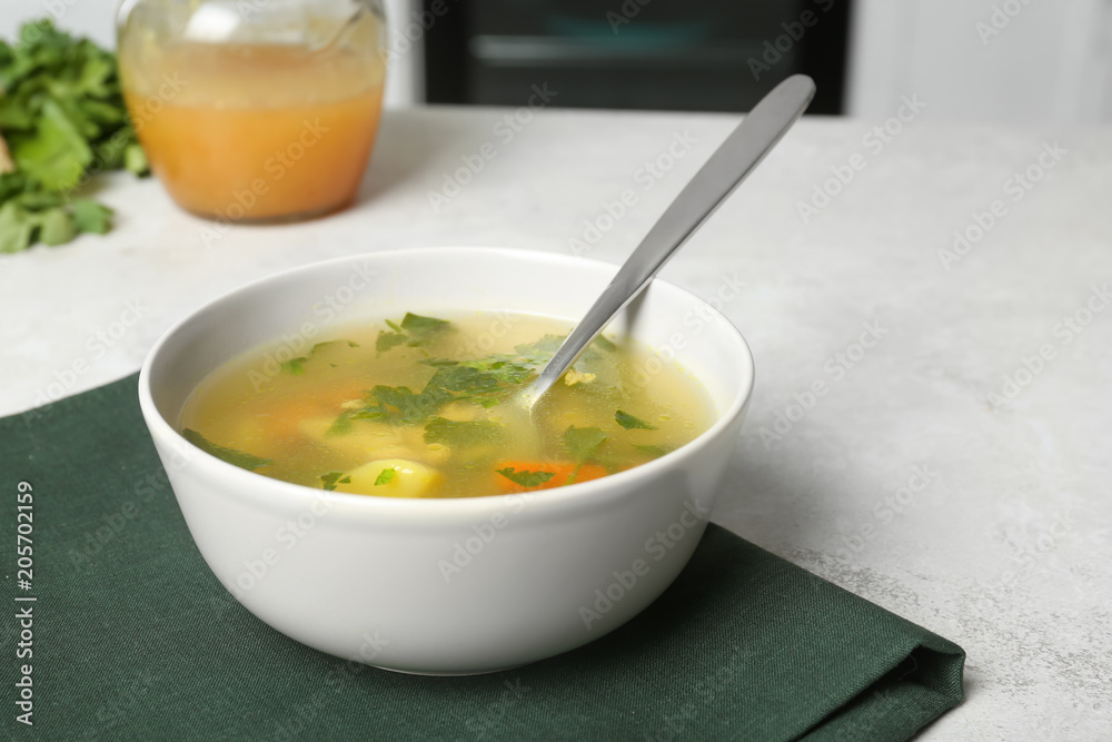 Bowl with delicious hot broth on table. Cold treatment Bowl with delicious hot broth on table. Cold treatment