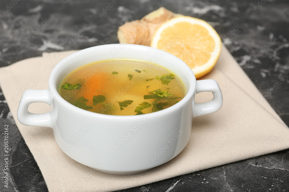 Dish with delicious hot broth on table. Cold treatment Dish with delicious hot broth on table. Cold treatment