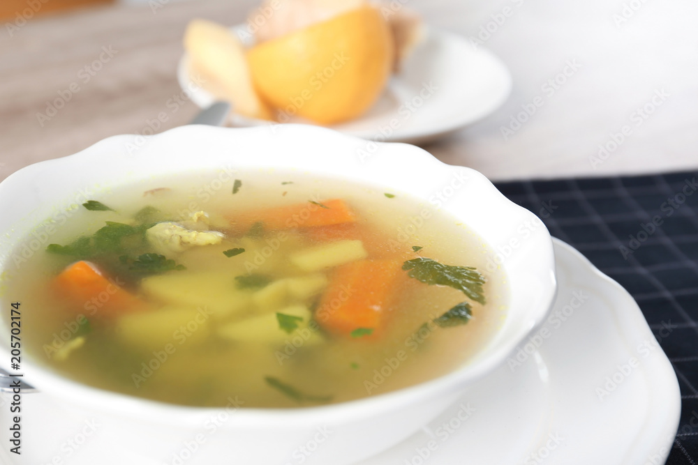 Bowl with delicious hot broth on table. Cold treatment Bowl with delicious hot broth on table. Cold treatment
