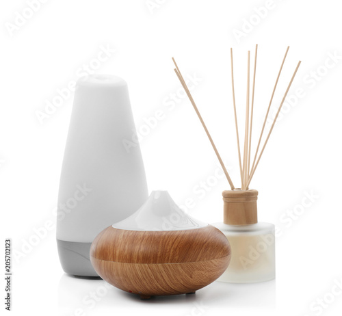 Different aroma oil diffusers on white background. Air freshening