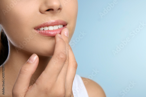 Young woman with sexy lips on color background  closeup