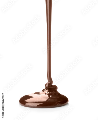 Pouring delicious melted chocolate on white background