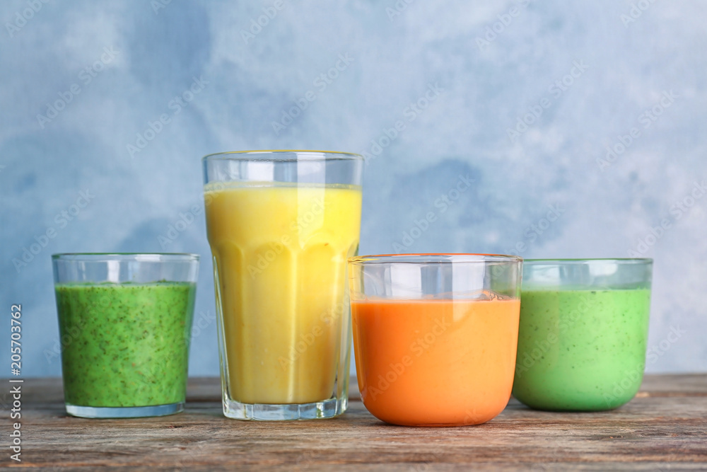 Glasses with delicious detox smoothies on table Glasses with delicious detox smoothies on table