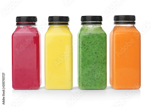 Bottles with delicious detox smoothies on white background