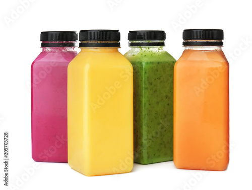 Bottles with delicious detox smoothies on white background