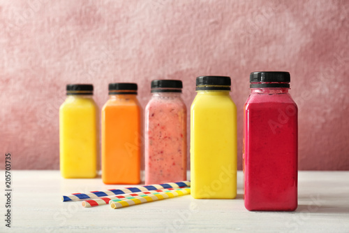 Bottles with delicious detox smoothies on table