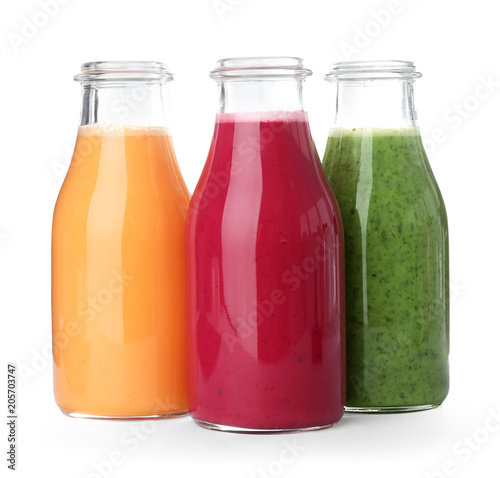 Bottles with delicious detox smoothies on white background