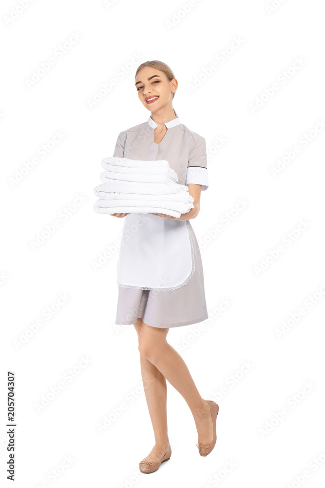 Young chambermaid with stack of clean towels on white background Young chambermaid with stack of clean towels on white background