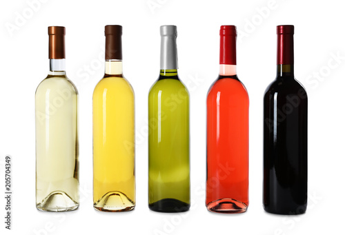 Bottles of expensive wines on white background