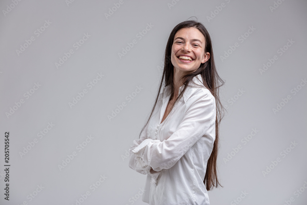 Long-haired cheerful woman with arms crossed Long-haired cheerful woman with arms crossed