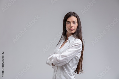 Long-haired brunette woman with arms crossed