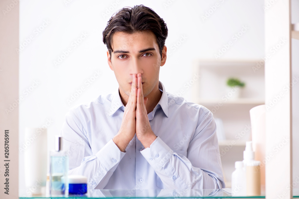 Man is getting dressed up for work in bathroom Man is getting dressed up for work in bathroom