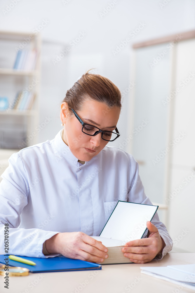 Woman doctor reading book