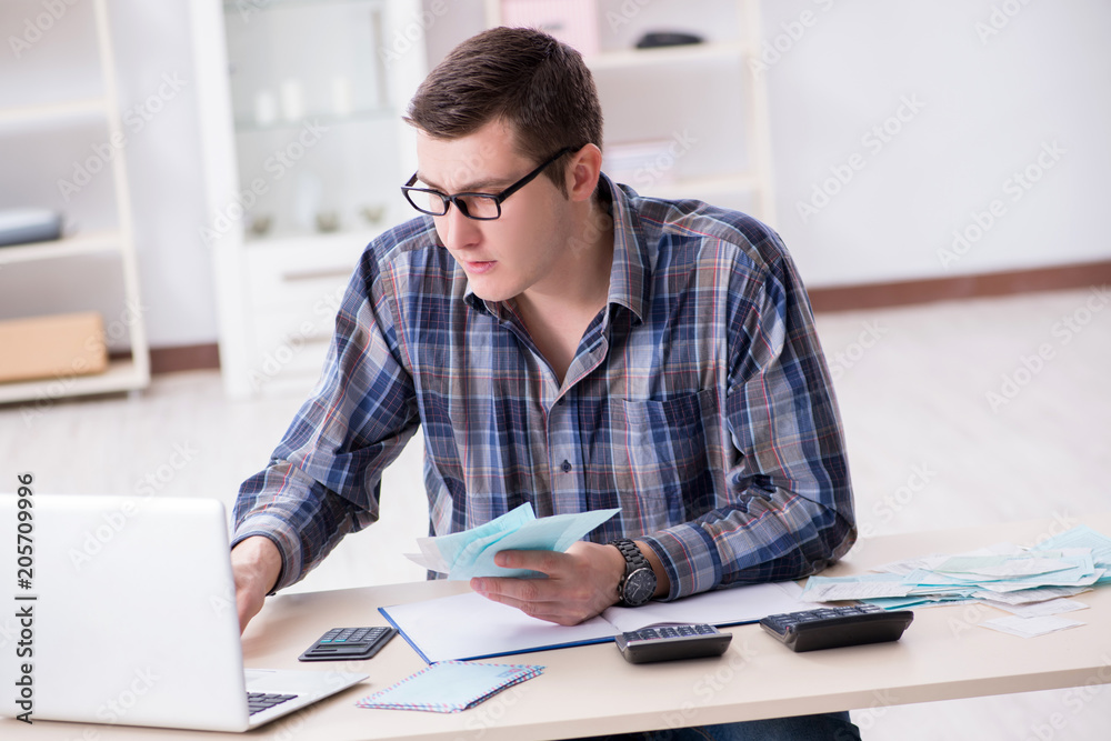 Young man frustrated at his house and tax bills Young man frustrated at his house and tax bills