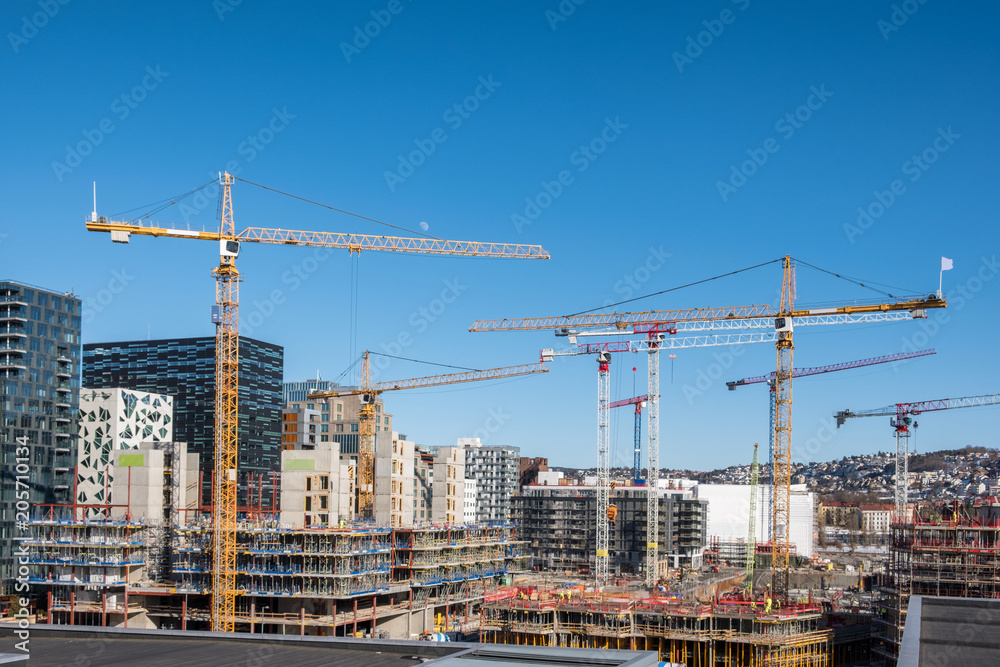Construction building with cranes and derrick