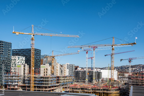 Construction building with cranes and derrick