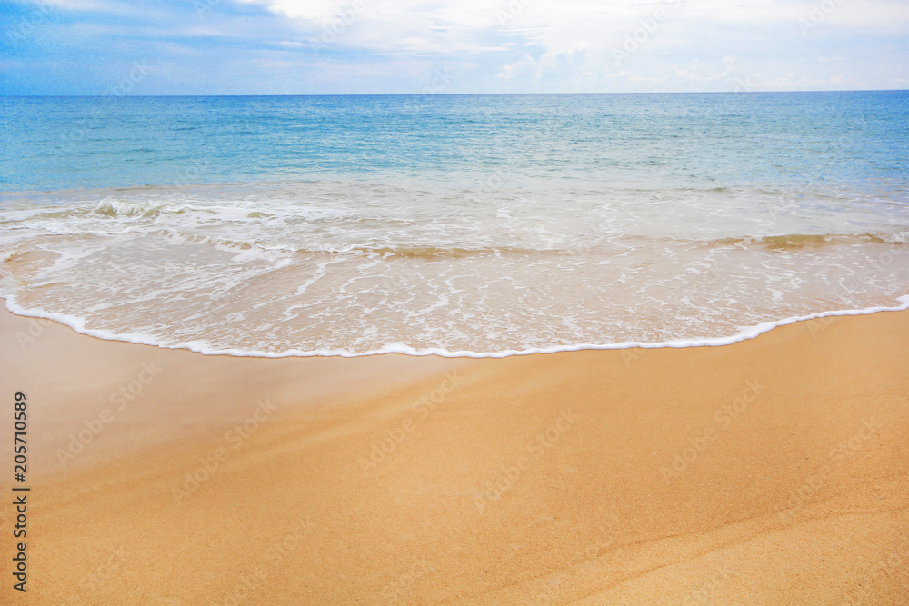 Soft wave of blue ocean on sandy beach. Background.