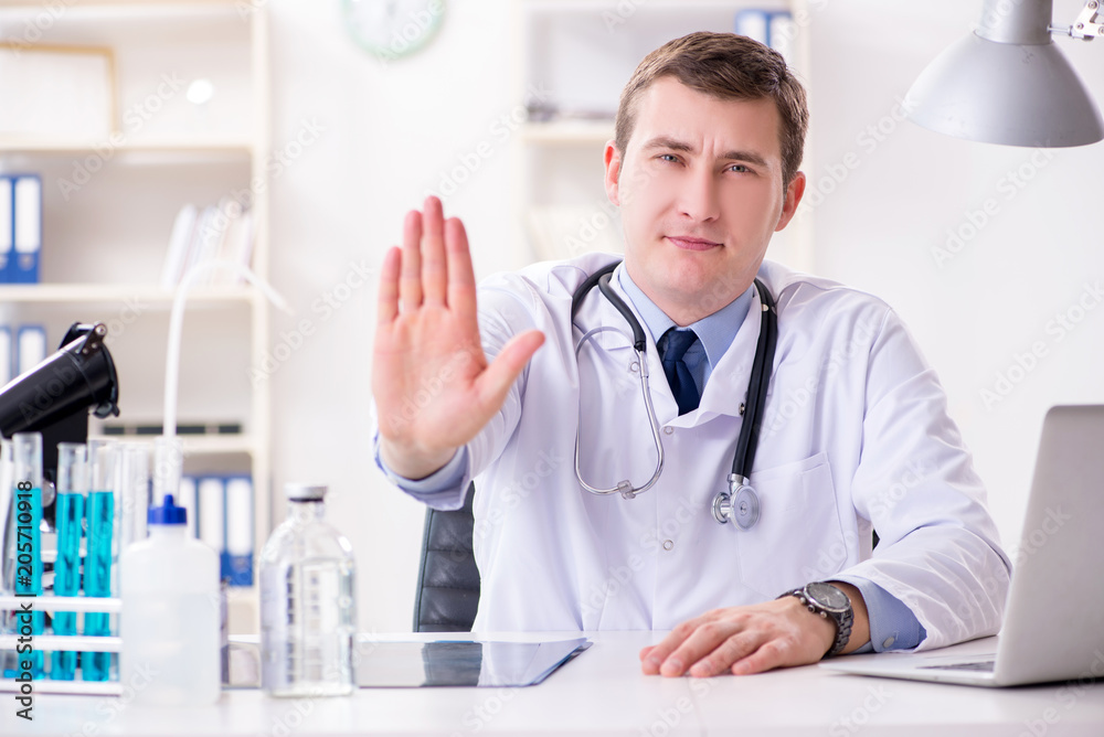 Male doctor looking at lab results in hospital Male doctor looking at lab results in hospital