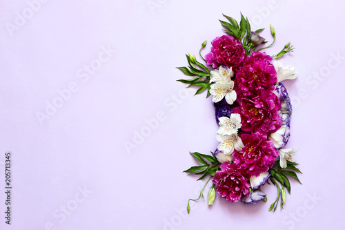 festive floral composition of peonies on pink and purple background .