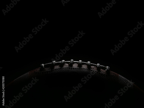 Laces of an American Football Game Ball Lit from Overhead