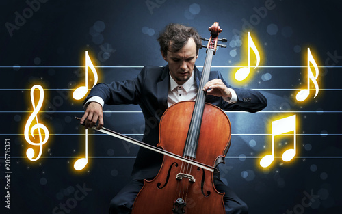 Young handsome cellist playing with music sheet background