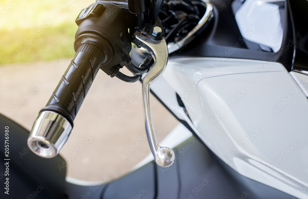 Close up of selective focus handlebars and front break on motorcycle