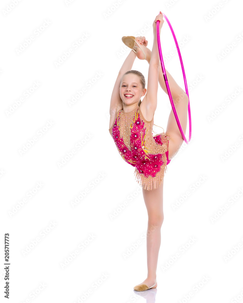 The gymnast balances on one leg. The gymnast balances on one leg.