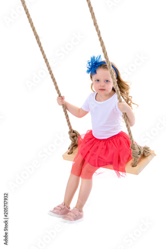 Little girl swinging on a swing