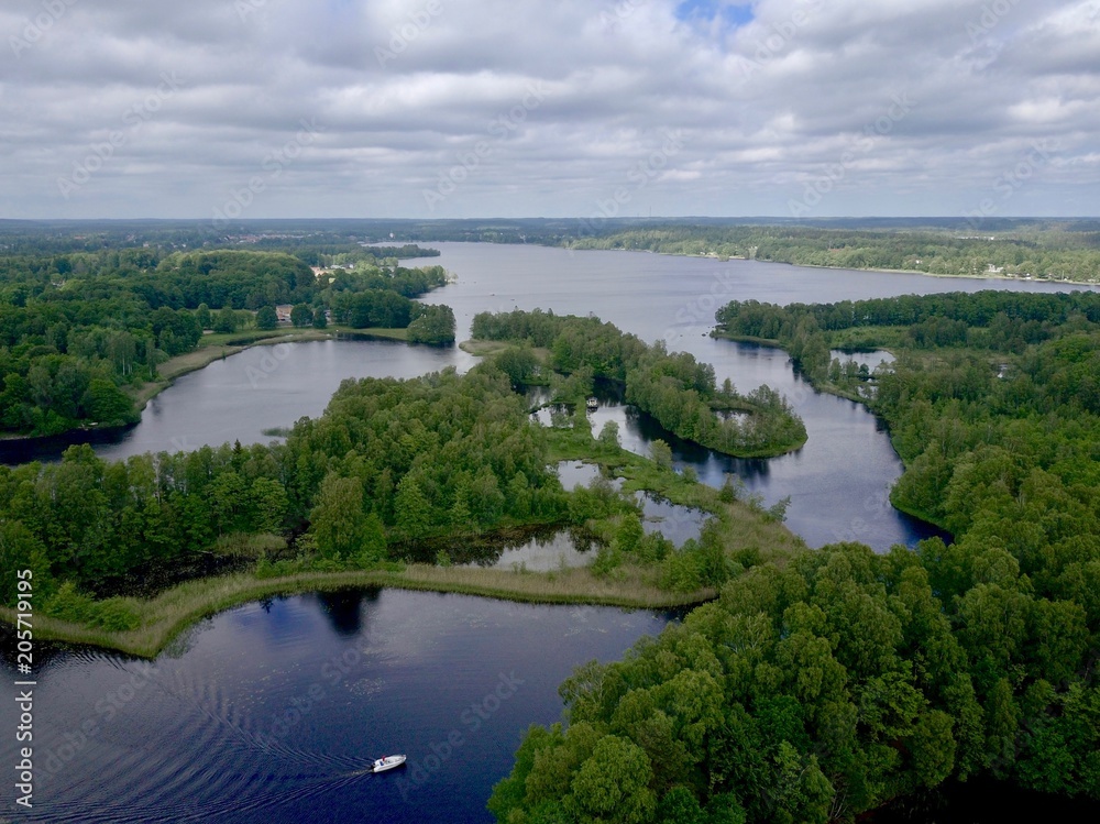 Complex sit of small islands and marsh which form almost a separation on a big lake, Summer in Sweden