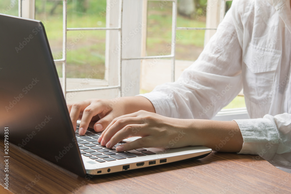 Fototapeta premium Beautiful hands on the keyboard.and Nature view background,