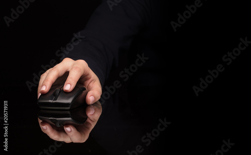 Hand using wireless mouse in a dark environment 